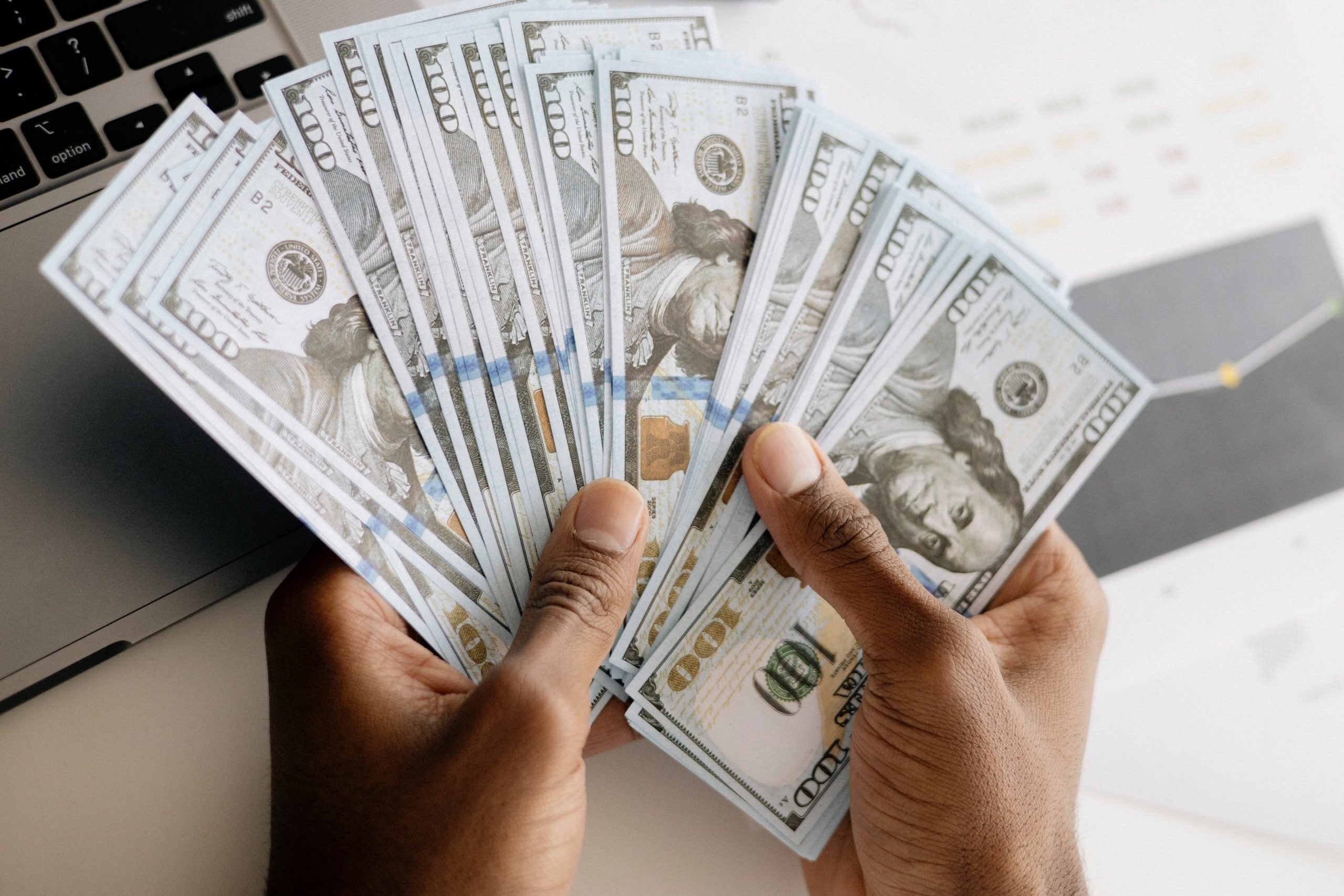 Image of a stack of bills, money.