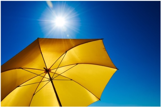 Image of a yellow umbrella blocking the sun.
