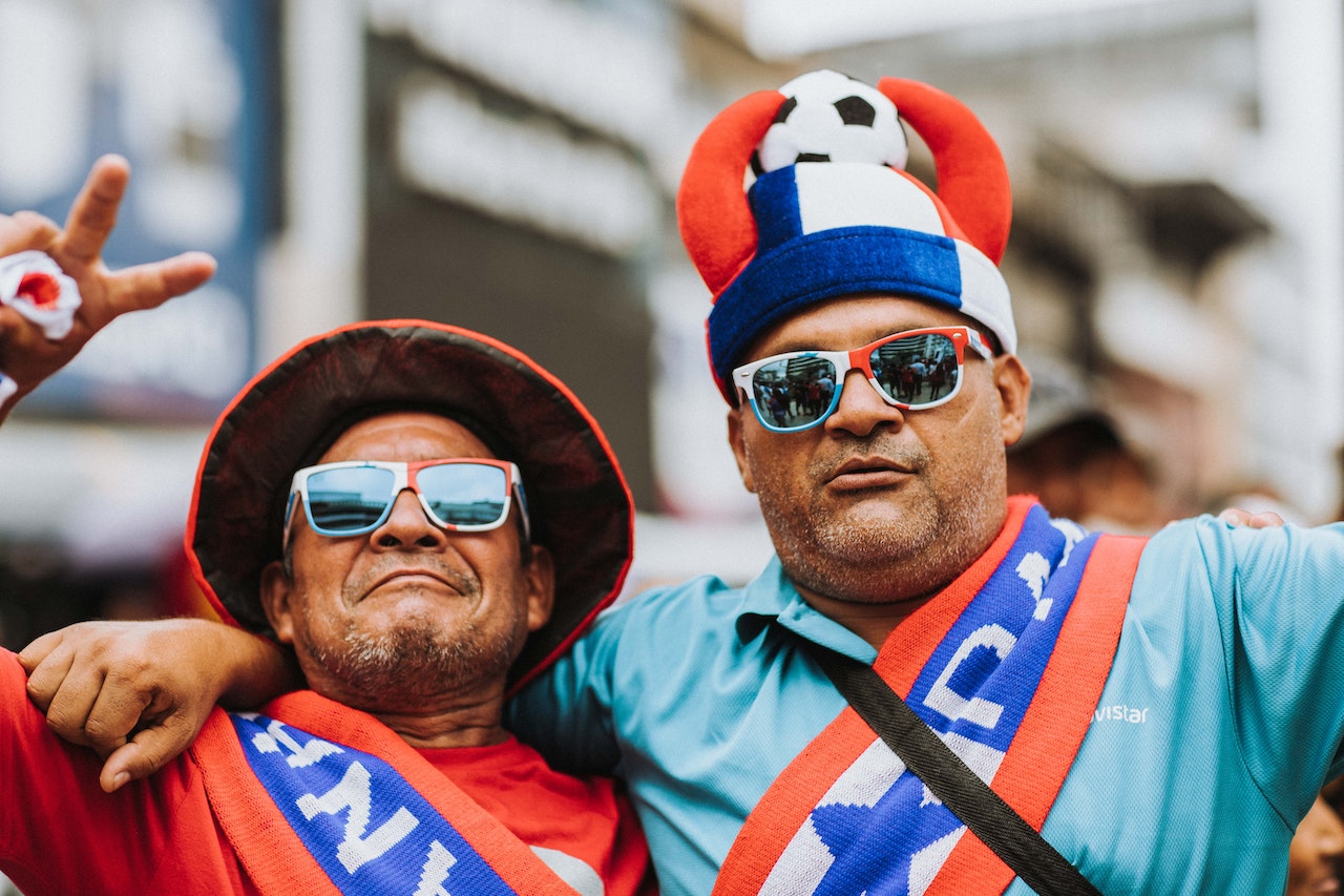 Soccer fans decked out in their team colors.
