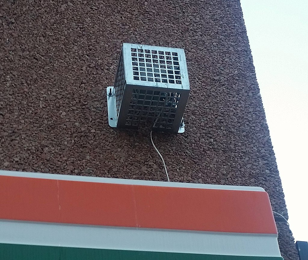 The mosquito sound device shown as a box on the side of a building