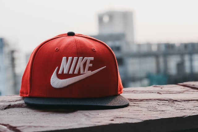 Red and black cap embroidered with NIKE and swoosh symbol in white