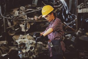 woman in a factory fixing machinery