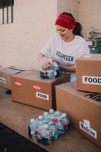 a volunteer unpacks packages of water and boxes