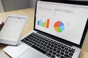 laptop displaying bar graph and pie chart