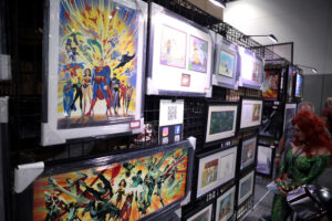 A cosplayer dressed as comic book character Poison Ivy looks at illustrations in the Justice League exhibit booth at the San Diego Comic-Con