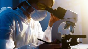 Woman looking through a microscope