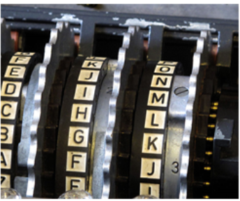 An enigma machine, showing several wheels with the alphabet on them.