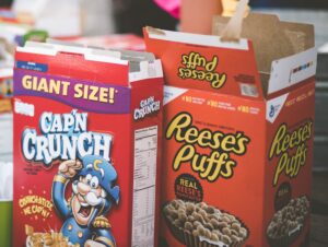 Cap'n Crunch and Reese's Puffs cereal boxes.