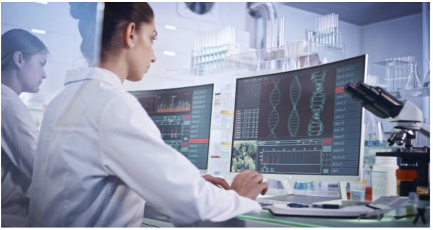 Two scientists at a computer looking at data.