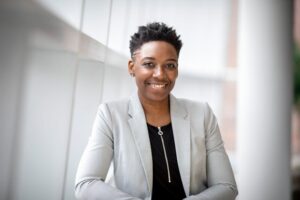 A photo portrait of a person wearing blazer over a shirt