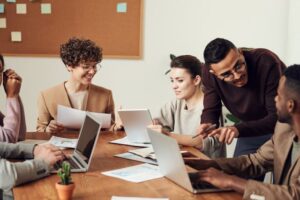 Teammates working around an office conference table