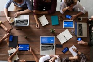 Overhead view of co-workers sitting around a table and working