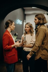 Three people having a conversation at a business social event