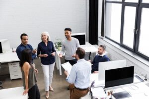 co-workers of different ages gathered for casual conversation in the office