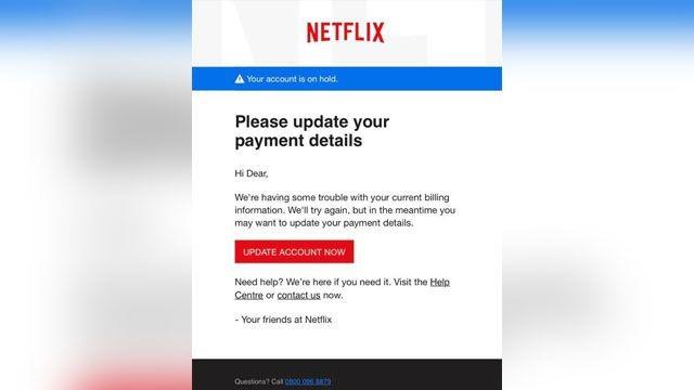This image, sourced from the FTC (Federal Trade Commission), shows a phishing email designed to look like it is from Netflix. The email has the Netflix logo at the top and a message stating, "Your account is on hold." It prompts the recipient to update their payment details with a red button labeled "UPDATE ACCOUNT NOW." The email addresses the recipient as "Hi Dear" and mentions an issue with the current billing information, suggesting they visit the Help Centre or contact Netflix for assistance. The email also includes a customer support phone number at the bottom.